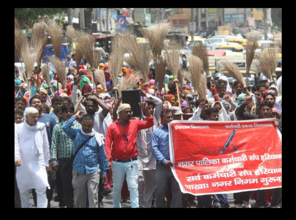 Sanitary workers holding placards demanding payment of pending salaries at Hyderabad Secretariat